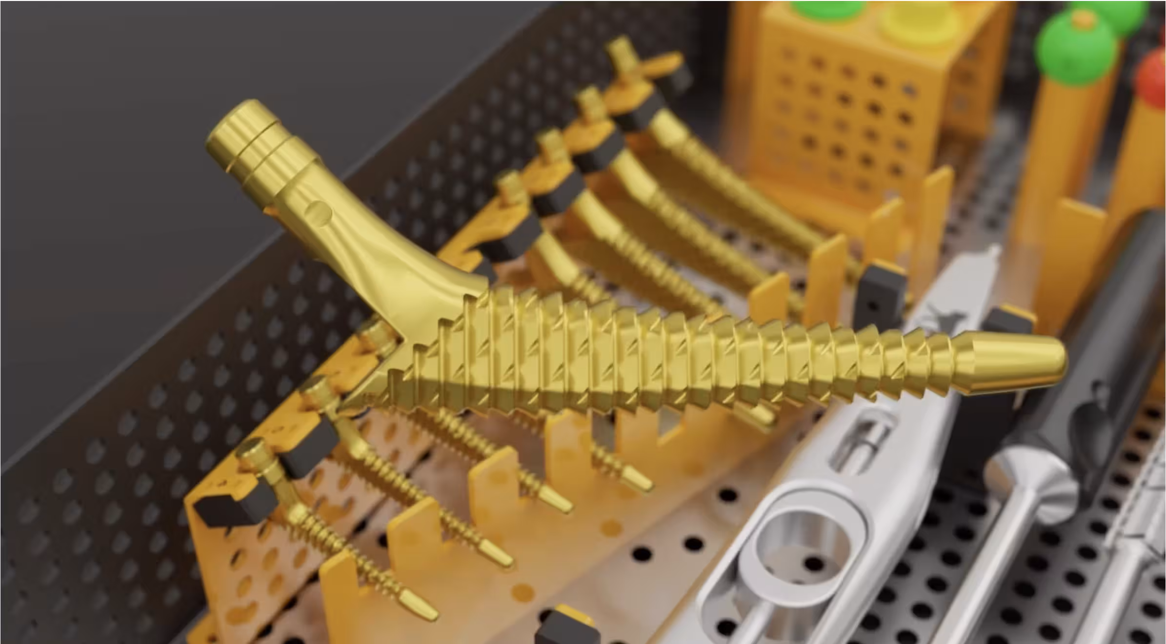 Angled view of gold surgical tools organized inside a sterilization tray.